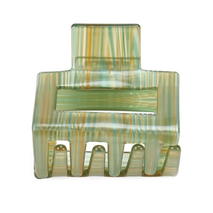 Macro shot of large square hair claw clip with green and yellow marble acetate texture
