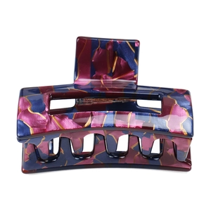 Detail of a geometric medium hair claw clip with purple and blue marble pattern