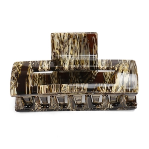 Detail showing high-gloss square hair claw with vintage brown tortoiseshell marble texture