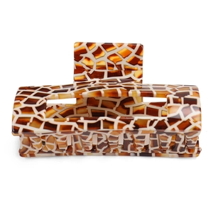Detail view of large rectangular acetate hair claw clip with amber tortoise shell pattern