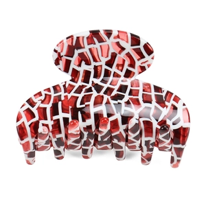 Detail of red and white mosaic acetate hair claw clip with glossy finish and strong grip