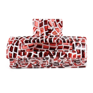 Detail view of large rectangular acetate hair claw clip with red and white mosaic pattern