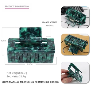 Detailed size view of geometric acetate hair claw with dark green marble texture