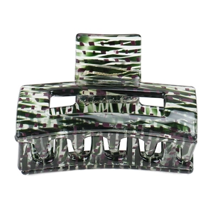 Detailed view of the green and purple geometric pattern on the acetate hair claw clip