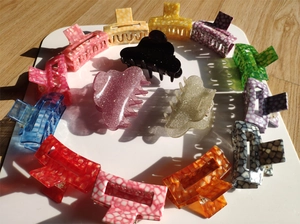 Top view of various colorful acetate hair claws with marble and glitter patterns