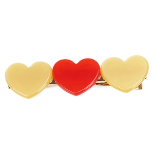 Detail of candy color heart hair clip with yellow and red hearts on a gold metal base