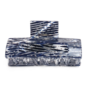 Detailed macro view of large square acetate hair claw with blue and white marble texture