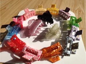 Selection of geometric acetic acid hair claws in various vibrant colors and marble patterns