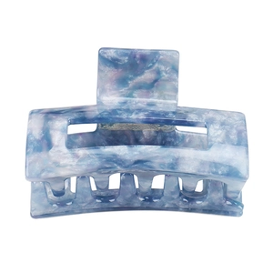 Detail of blue purple marble pattern hair claw clip with acetate mica texture