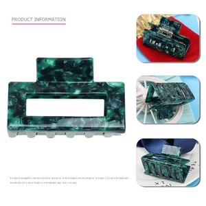 Detailed close-up of dark green marble patterned rectangular hair claw in acetate material