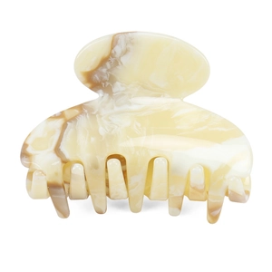 Detail view of medium acetate hair claw clip featuring beige marble texture patterns