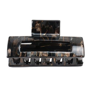 Detailed macro view of large square tortoise acetate hair claw clip with dark marble texture