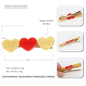 Colorful acetate heart hair clip for women featuring cream and red hearts on a gold metal base