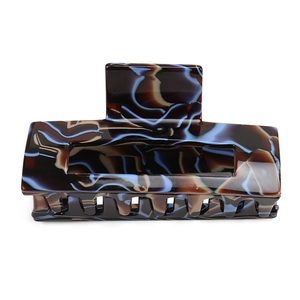 Detail view of large marble texture acetate hair claw clip with rectangle hollow design