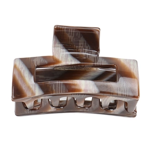 Detail of rectangular hair claw clip with tortoise pattern and vertical texture lines