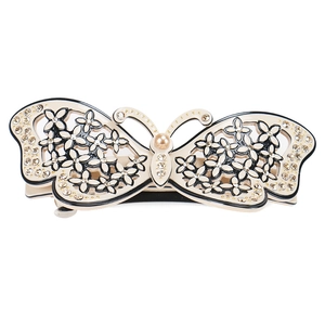 Detail of acetate butterfly hair clip with champagne crystals and pearl center
