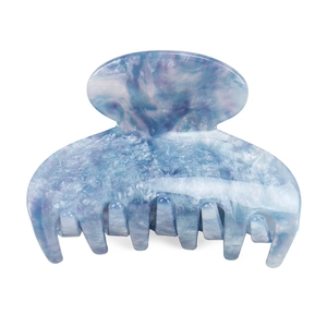 Close-up of blue marble acetate hair claw clip with smooth texture and sturdy teeth