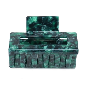 Detailed close-up of dark green marble acetate hair claw clip with hollow rectangle design