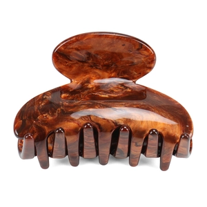 Detail view of the polished tortoiseshell acetate hair claw clip with strong metal spring