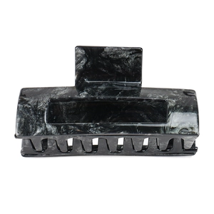 Macro detail of large acetate hair claw clip with black grey marble pattern