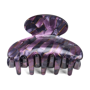 Detail view of purple marble acetate hair claw clip with golden streaks and pearly finish