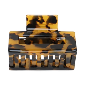 Detail view of large rectangular tortoiseshell acetate hair claw clip with glossy finish