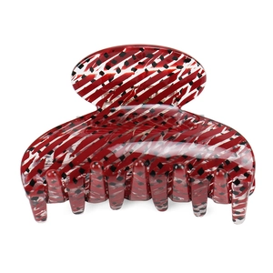Close-up of red and black striped acetate hair claw clip with glossy finish