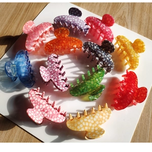 Macro view of multi-color geometric acetate hair claws with marble texture details
