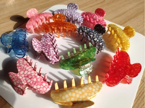Detailed macro view of assorted marble pattern acetate hair claws in various vibrant colors