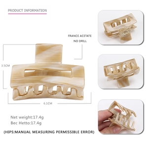 Minimalist beige acetate hair claw clip with marble texture and dimensions 6.1cm x 3.5cm
