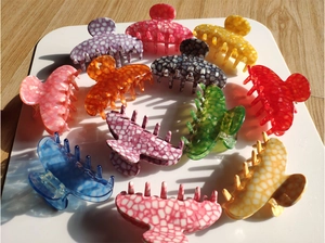 Detail of colorful hollow acetate hair claws with marble and checkerboard patterns