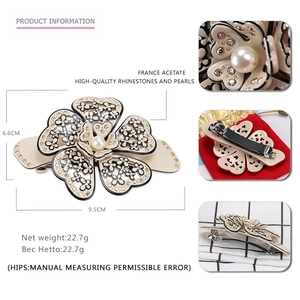 Detail of camellia acetate hair clip with pearls, rhinestones and dimension markings