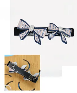 Detail view of acetate bow hair clip with rhinestones, spring clip back, 3.7x8.6cm