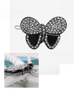Detail view of black acetate butterfly hair clip with high-quality white rhinestones