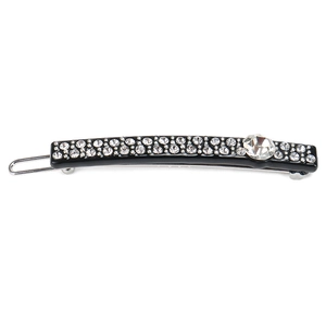 Detail of a black acetate hair clip with shimmering rhinestones and a metal spring