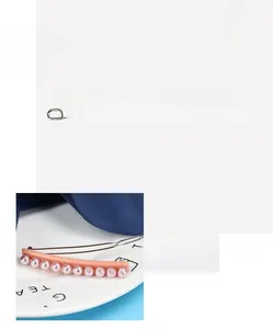 Close-up of pink acetate hair clip featuring eleven elegant faux pearls in a row