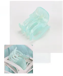 Detail view of small blue acetate floral hair claw clip with 4.6cm size and smooth finish
