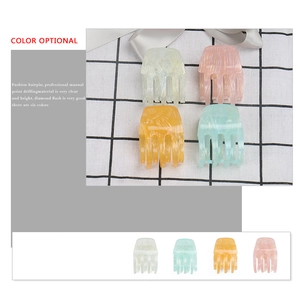 Floral acrylic hair claw clips set in marble colors including yellow, pink, and green