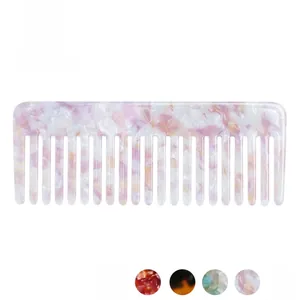 Close-up of a wide-tooth acetate hair comb with trendy pink and purple marble texture