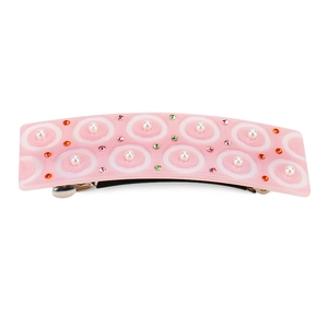 Détail de la barrette rose en acétate avec cercles blancs, perles et strass colorés