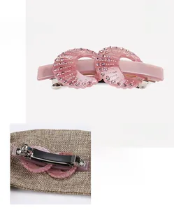 Detail of pink acetate hair clip with sparkling rhinestones and silver metal fastener