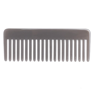Macro shot of translucent dark grey wide-tooth hair comb for styling curly hair