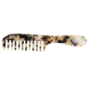 Detail of wide-tooth tortoiseshell cellulose acetate hair comb with smooth rounded tips