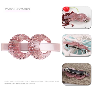 Elegant pink acetate hair clip with circular cutout design and sparkling inlaid rhinestones