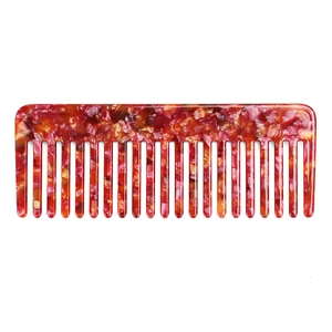 Close-up of tortoise shell pattern hair comb made of premium acetate in warm marble tones