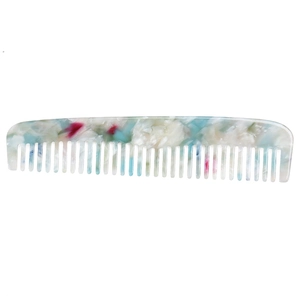 Macro detail of anti-static marble texture acetate comb with blue and pink patterns
