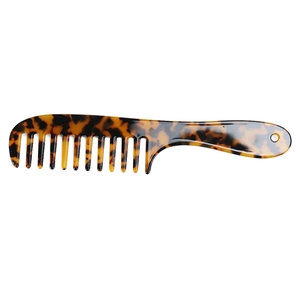 Macro view of wide-tooth tortoise shell comb made of acetate with hanging hole detail