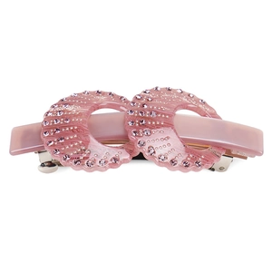 Close-up of pink acetate hair clip with hollow circles and purple rhinestones
