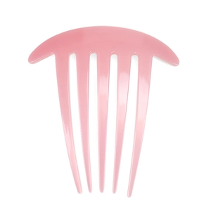 Detail of a minimalist pink acetate 7-tooth hair comb with smooth polished surface finish
