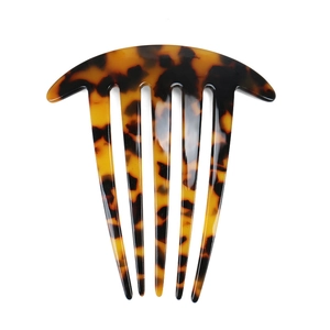 Close-up of tortoise shell pattern acetate hair comb with six teeth for hair styling